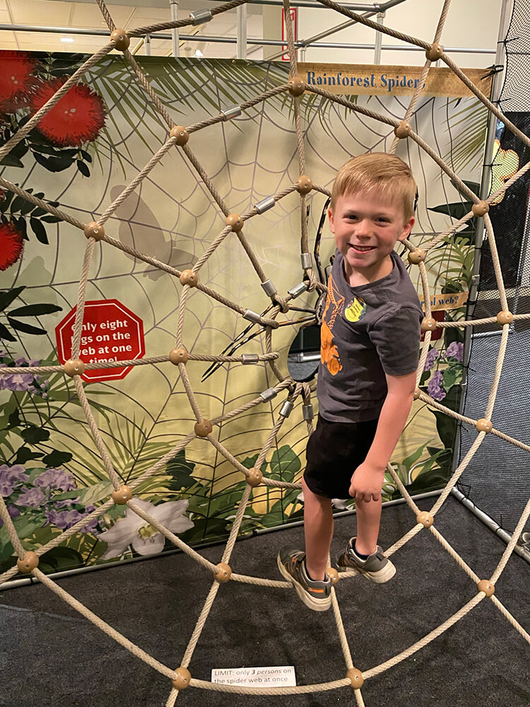 child climbing on a rope activity